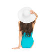 model sitting in swimsuit with hat