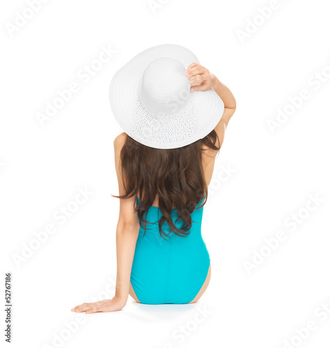 Photo: model sitting in swimsuit with hat model sitting in swimsuit with hat