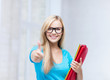 smiling student with folders