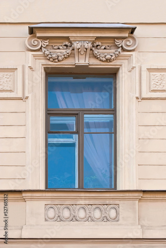 Photo: A window with a bas-relief. A window with a bas-relief.