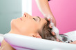 Woman at the hairdresser washing hair