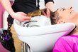 Woman at the hairdresser washing hair