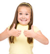 Little girl is showing thumb up gesture