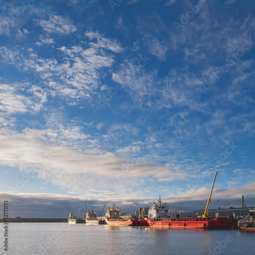 Photo: Oil platform supply vessels in a port during sunrise Oil platform supply vessels in a port during sunrise