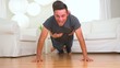 Mexican man carrying woman while doing pushups