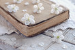 Cherry flowers laying upon old book on lace doily