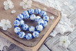 Two white and blue bracelets on vintage book