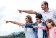 Happy Family Pointing Away