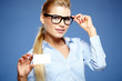 Zdjęcie: Businesswoman holding credit card. Isolated on blue Businesswoman holding credit card. Isolated on blue