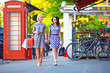 Photo: two elegant women walking the city street two elegant women walking the city street