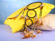 Beautiful dream catcher and pillows on blue background