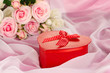 Beautiful gift on flowers background