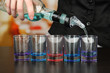 Barmen hand with bottle  pouring beverage into glasses,
