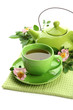 Cup and teapot of herbal tea with hip rose flowers, isolated