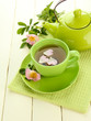 Cup and teapot of herbal tea with hip rose flowers