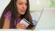 Mexican woman making online purchase using laptop computer in be