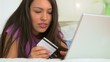 Mexican woman making online purchase using laptop computer in be