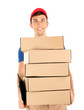 Young delivery man holding parcels, isolated on white