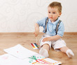 Adorable 2 year old boy covered in bright paint.