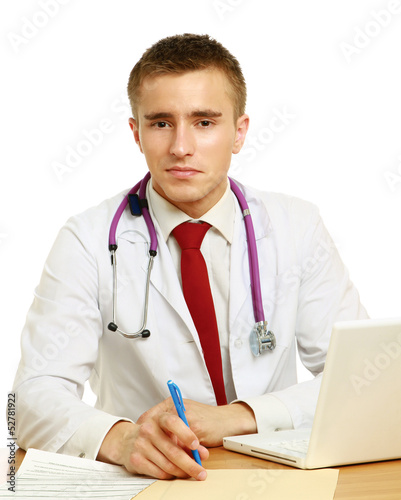Photo: The doctor writing on the desk The doctor writing on the desk
