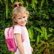 A young little girl preparing to walk to school