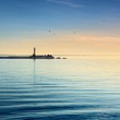 lighthouse in the sea at the colorful sunset