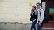 Students walking and talking on cellphone in the city