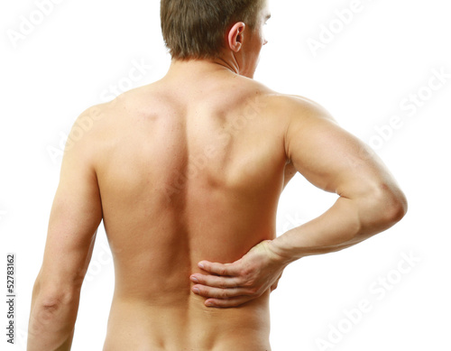 Photo: Young man with back pain. Isolated on white background Young man with back pain. Isolated on white background