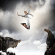 Young businesswoman jumping