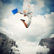 Young businesswoman jumping