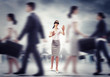 Businesswoman in blindfold among group of people