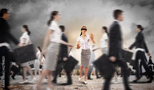 Photo: Businesswoman in blindfold among group of people Businesswoman in blindfold among group of people