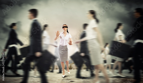 Photo: Businesswoman in blindfold among group of people Businesswoman in blindfold among group of people