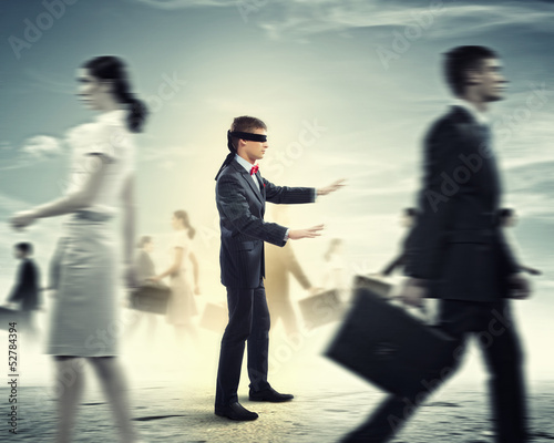 Photo: Businessman in blindfold among group of people Businessman in blindfold among group of people