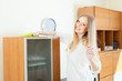 Photo: Happy long-haired housewife cleaning furniture Happy long-haired housewife cleaning furniture