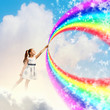 Little girl drawing rainbow
