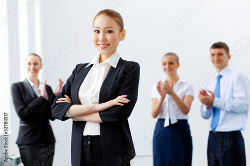 Photo: Four businesswomen standing in row Four businesswomen standing in row