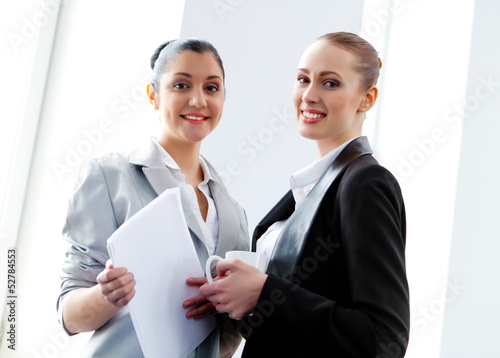 Photo: Two attractive business women smiling Two attractive business women smiling