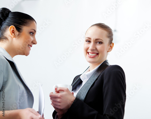 Photo: Two attractive business women smiling Two attractive business women smiling