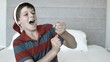 Happy boy using party popper in the bedroom in black and white