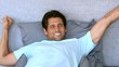 Video: Tanned man waking up and stretching Tanned man waking up and stretching