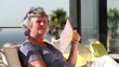 Woman fanning herself on the balcony