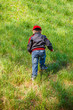 Little boy climbing to hill