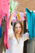 woman hanging clothes to dry on clothes-line