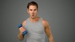 Video: Man exercising with dumbbell on grey background Man exercising with dumbbell on grey background