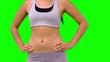 Athletic woman turning to camera against green screen