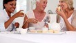 Three mature friends having cup cakes