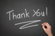 Blackboard with "Thank You" wrote on it with a hand.