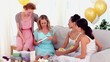 Friends having a party and giving their friend a card