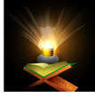 Open Islamic holy book Quran Shareef in illuminated lantern lig